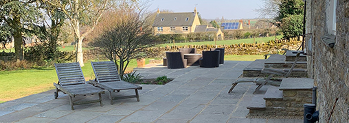 Stone patio in back garden of a country house